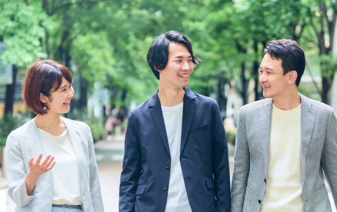 歩きながらラフに会話をする複数の社員